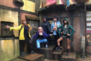 My group and I posing for our album cover - wearing raincoats and posing in the Oldtown area of Boomtown Fair