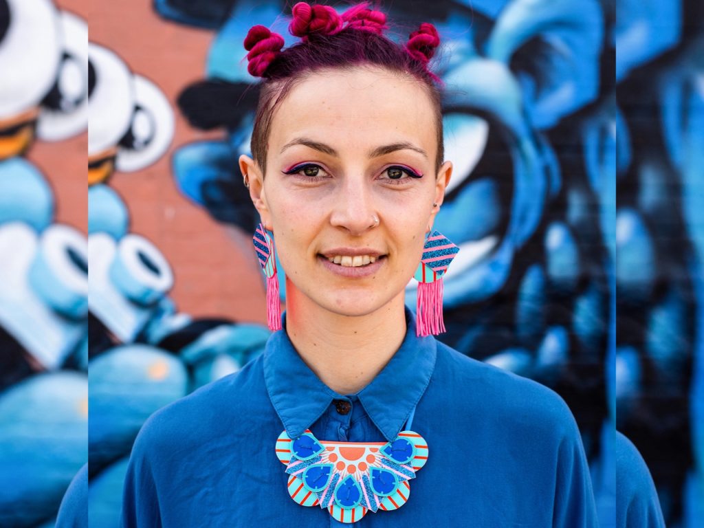 This model is wearing Dakota Rae Dust earrings and bib necklace, all in blue, pink and coral hues. These statement pieces really top off any festival fashion outfit!