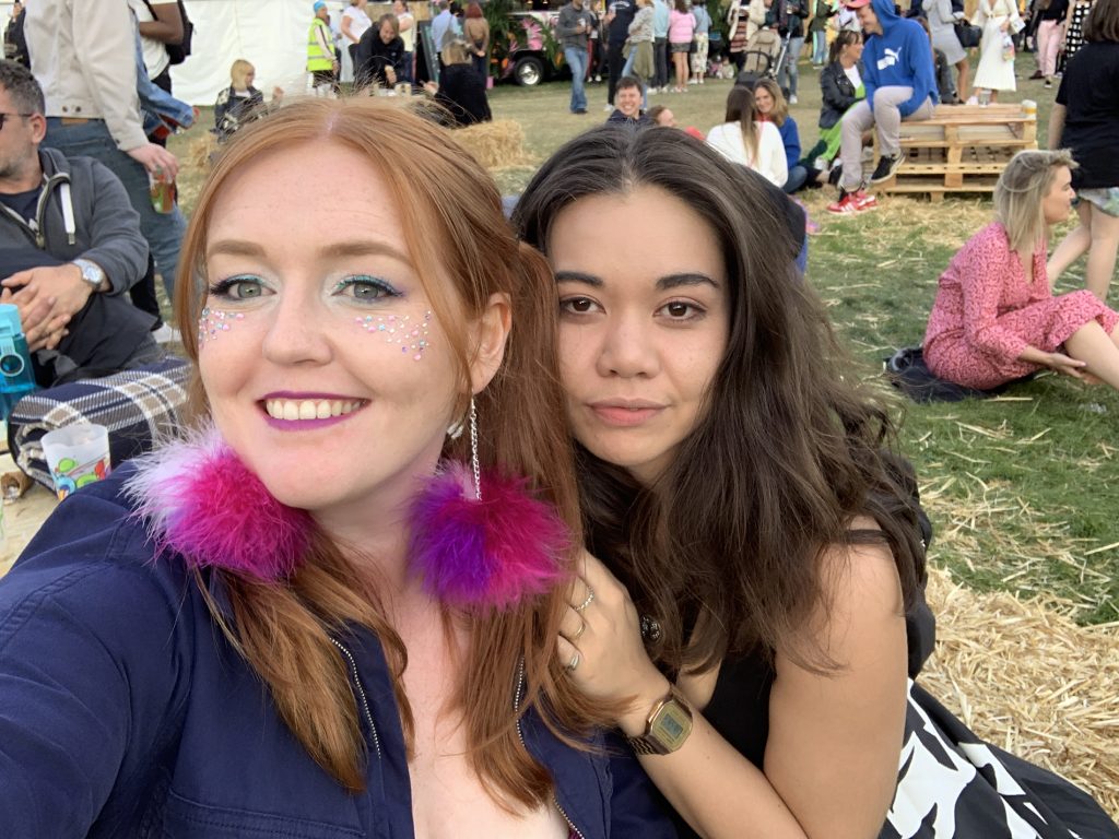 Katey and I smiling in our festival finest fashion! I'm wearing Shop Trashy fluffy pink earrings and gems on my face. Jam On Rye Festival 2019.