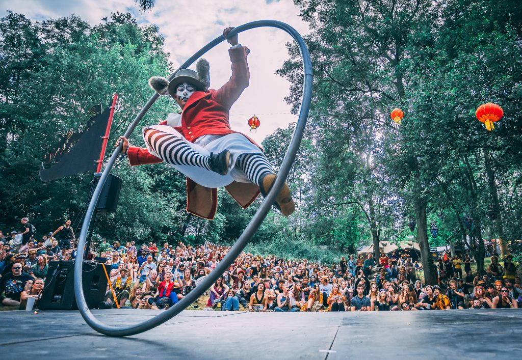 One of the circus performers at Noisily Festival 2019 - a rabbit in a hat spinning in a huge hoop wearing stripy leggings!