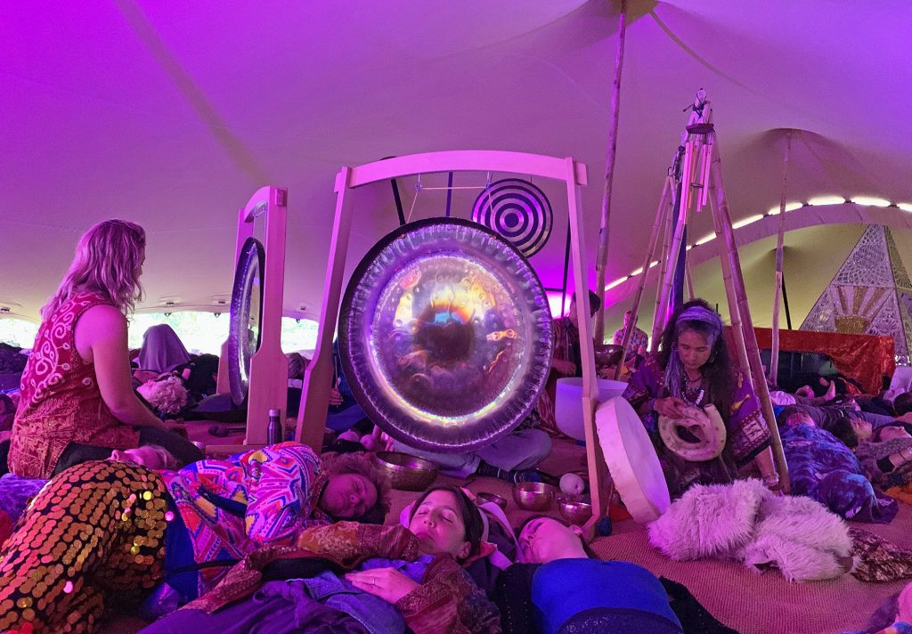 We tried a gong bath! Here we see all the attendees lying down with their eyes closed, and in the centre a number of large gongs being played. The tent had a purple hue. One of my favourite experiences of Noisily Festival 2019!