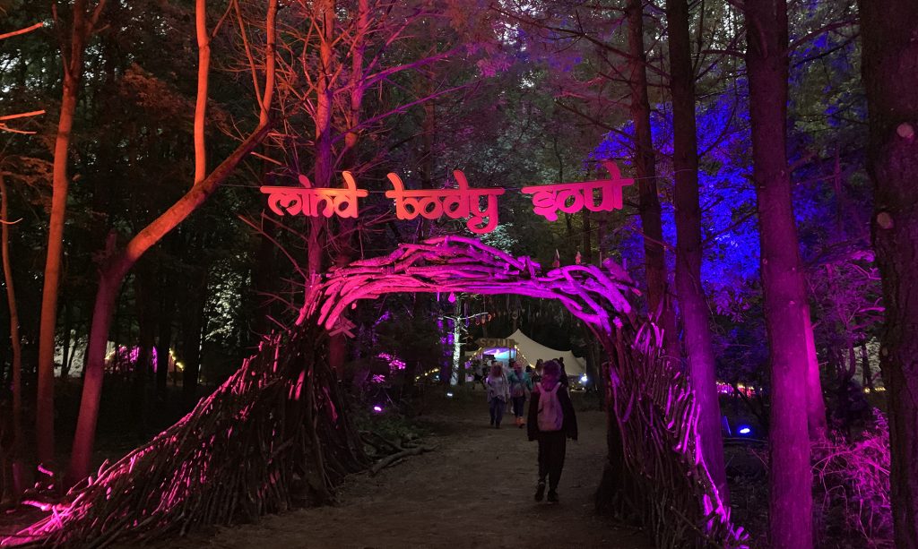 The Mind Body Soul area entrance lit up with coloured lights, leading into the woodland at Noisily
