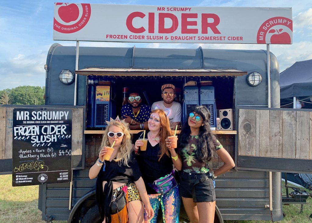 Us three girls stood in front of the Mr Scrumpy Cider van, holding our delicious frozen ciders, and smiling with the guys who served us the slushies!