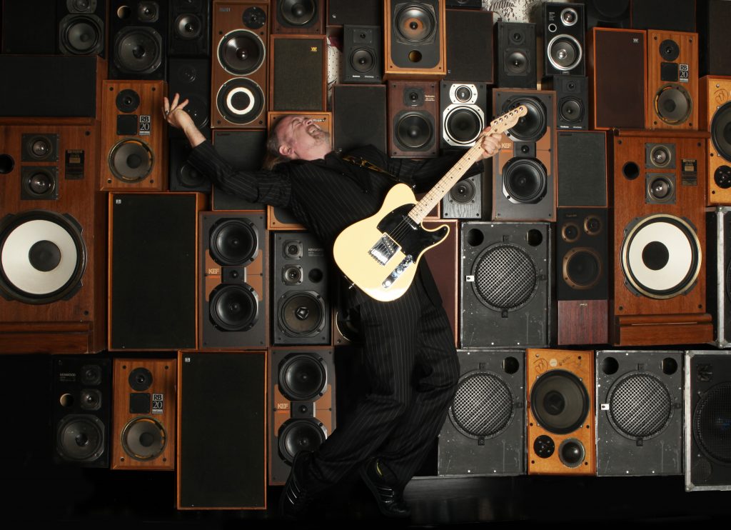 Bill Bailey rocking out playing a strat guitar in front of a wall of vintage speakers. I honestly am so excited that he's playing