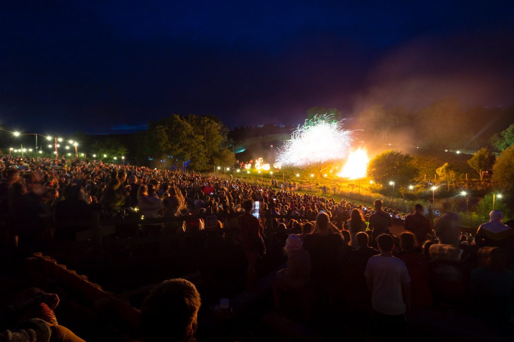 The huge crowd watching the Nozstock fire show in the valley, huge sparks and flames are on the opposite side of the valley looking spectacular. This reminds me of the Secret Garden Party's big show they used to do!