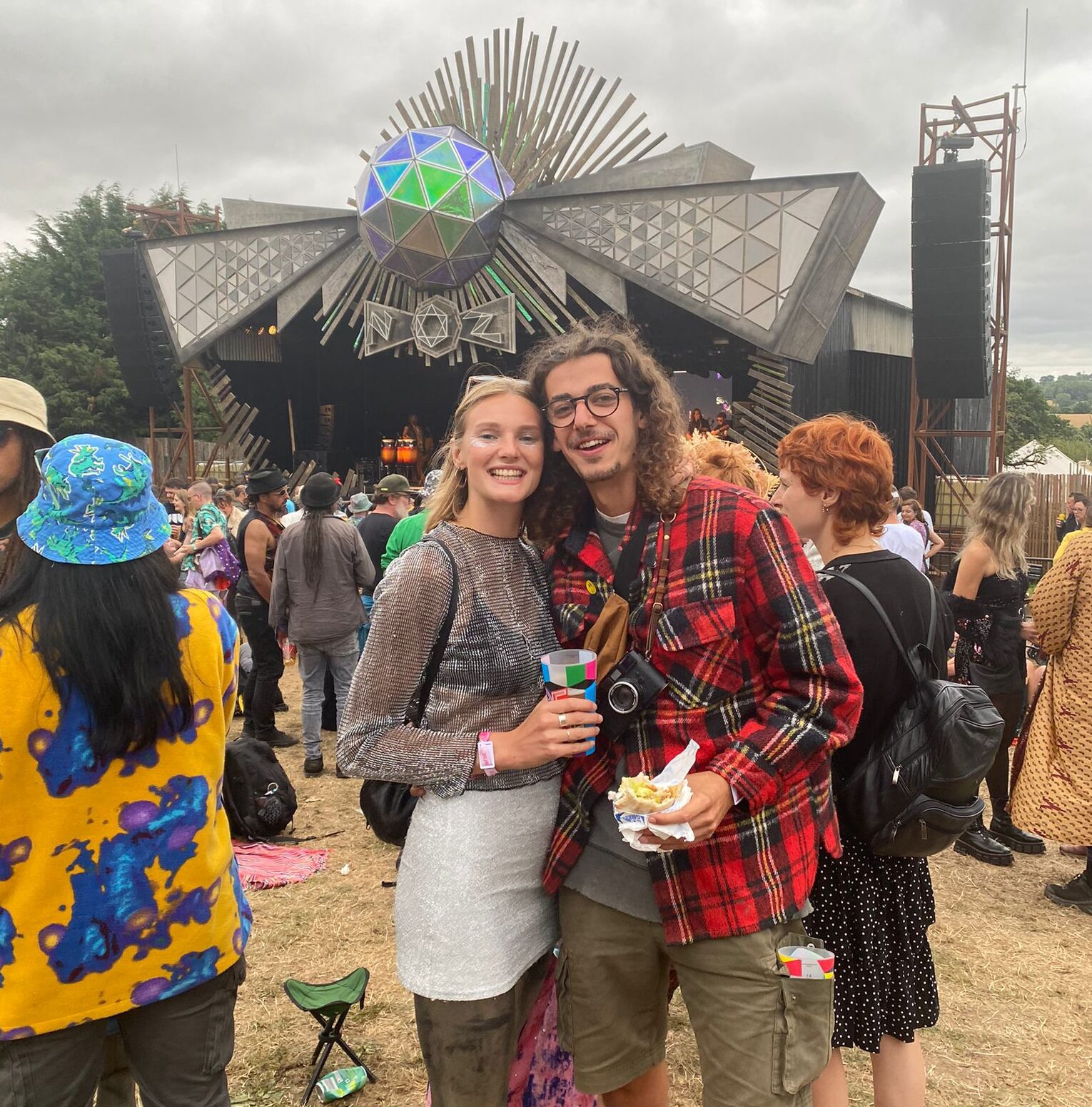 Ell and Henri stand in front of the main stage at Nozstock 2022 the Hidden Valley
