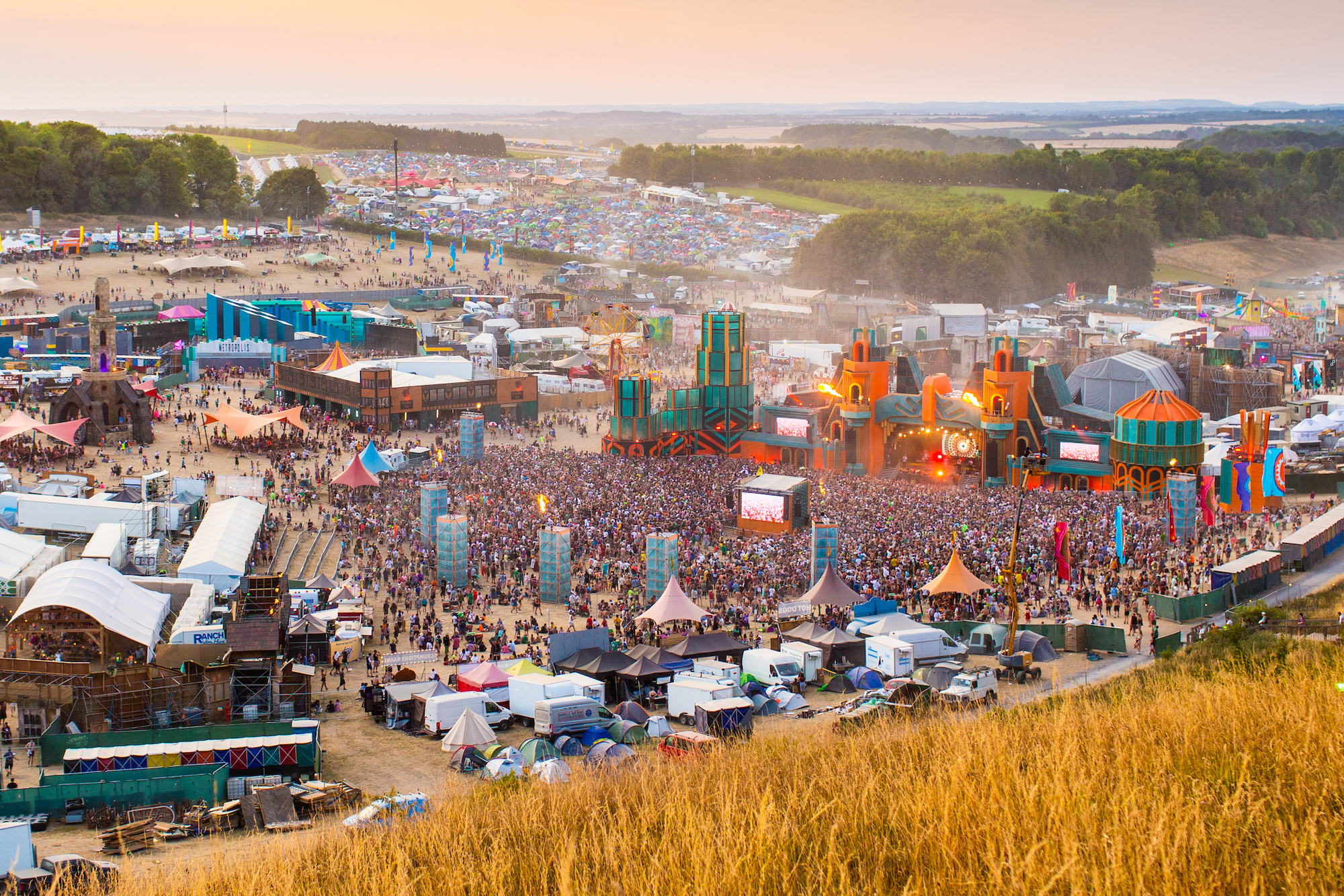 Taken from on the hill, the view of the whole Boomtown festival nestled inside the Matterley Bowl in Winchester. It shows the sheer size and complexity of the 'city'. The main part of the image is of the Grand Central stage.