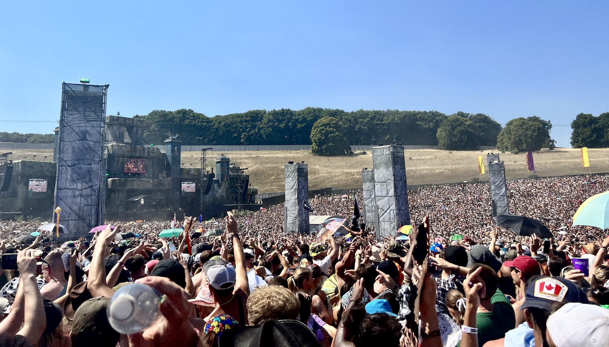 Our view from watching Shy FX on the Origin Stage at Boomtown 2022. Further back in the crowd, this shot shows just how huge the stage area is, with the crowd stretching all the way back. Blue skies, roasting temperatures!