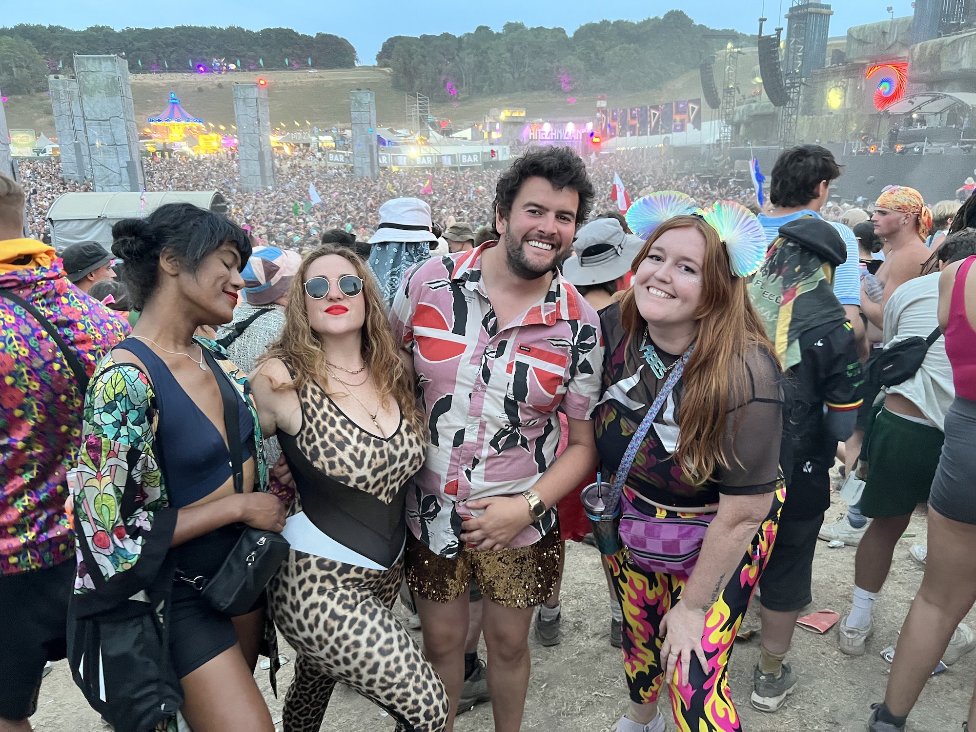 The fabulous four of Jessi, Ben, Alex and Laurie are in the huge crowd at Origin at dusk. There's a haze over the crowd and the lights are shining.